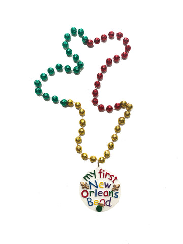 Médaillon "Ma première perle de la Nouvelle-Orléans" sur perles fantaisie rouges, vertes et dorées